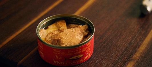 Open can of pole-caught wild albacore showing a whole solid tuna loin fillet