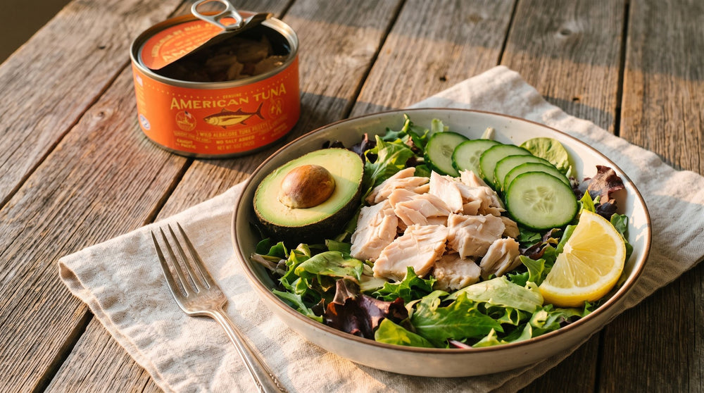 Albacore tuna salad bowl with avocado beside an American Tuna No Salt Added can