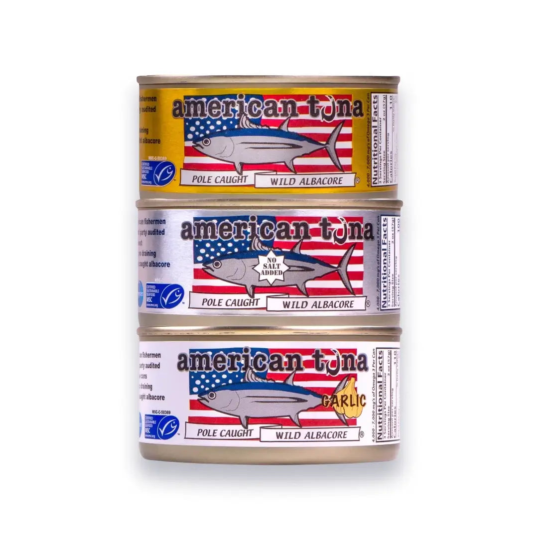 Three cans of American Tuna with labels on a white background