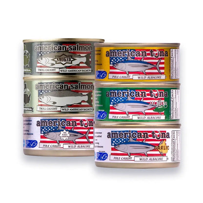 Collection of canned fish products with American-themed labels on a white background