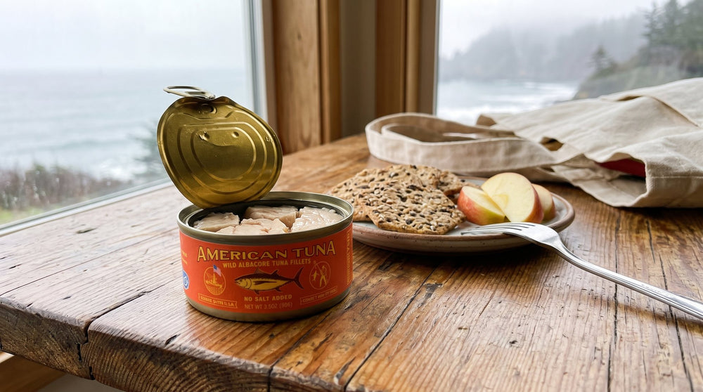 Opened 3.5 oz American Tuna No Salt Added can with crackers and apple slices